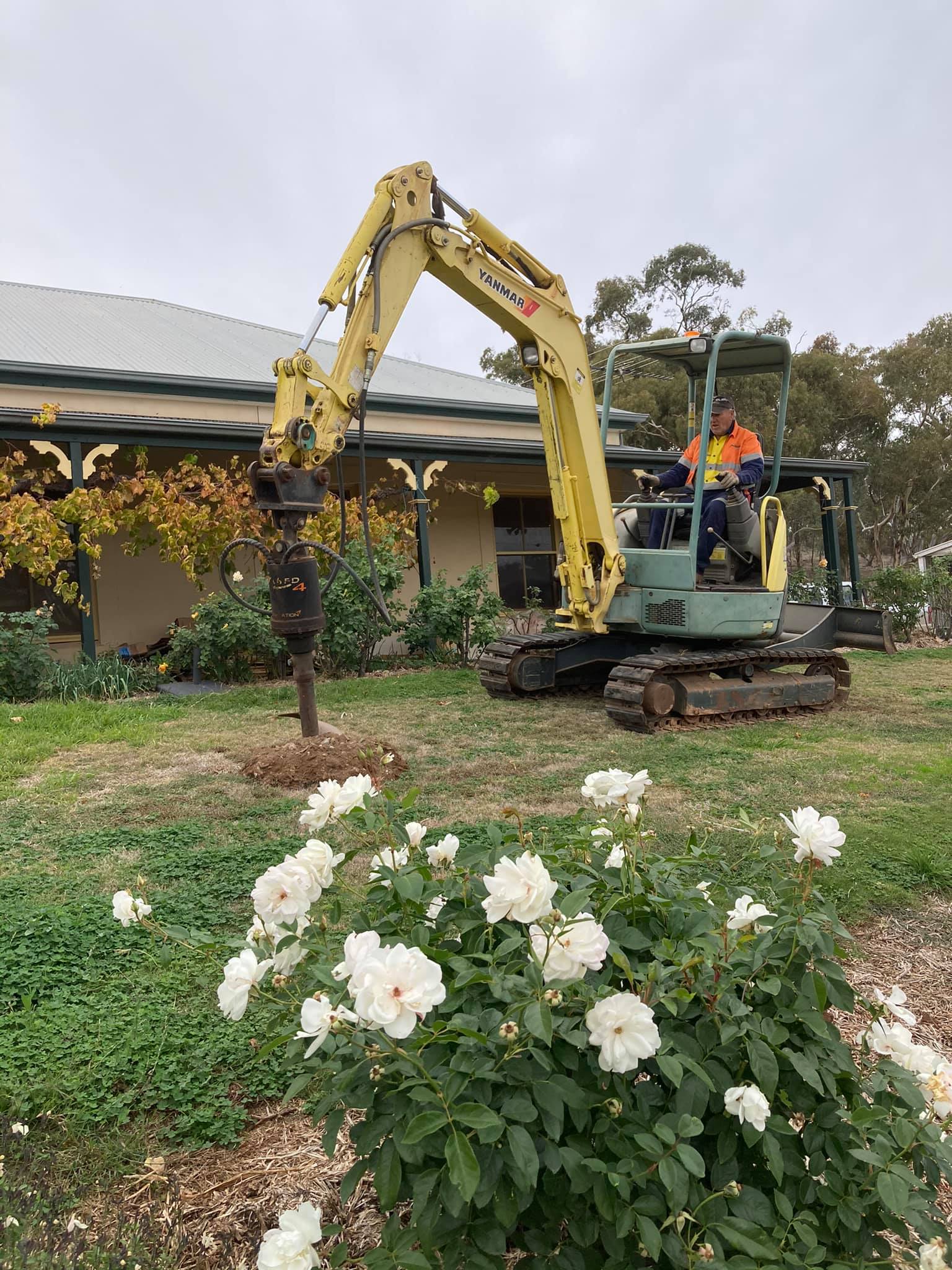 post hole digging with screw auger attached to reach excavator