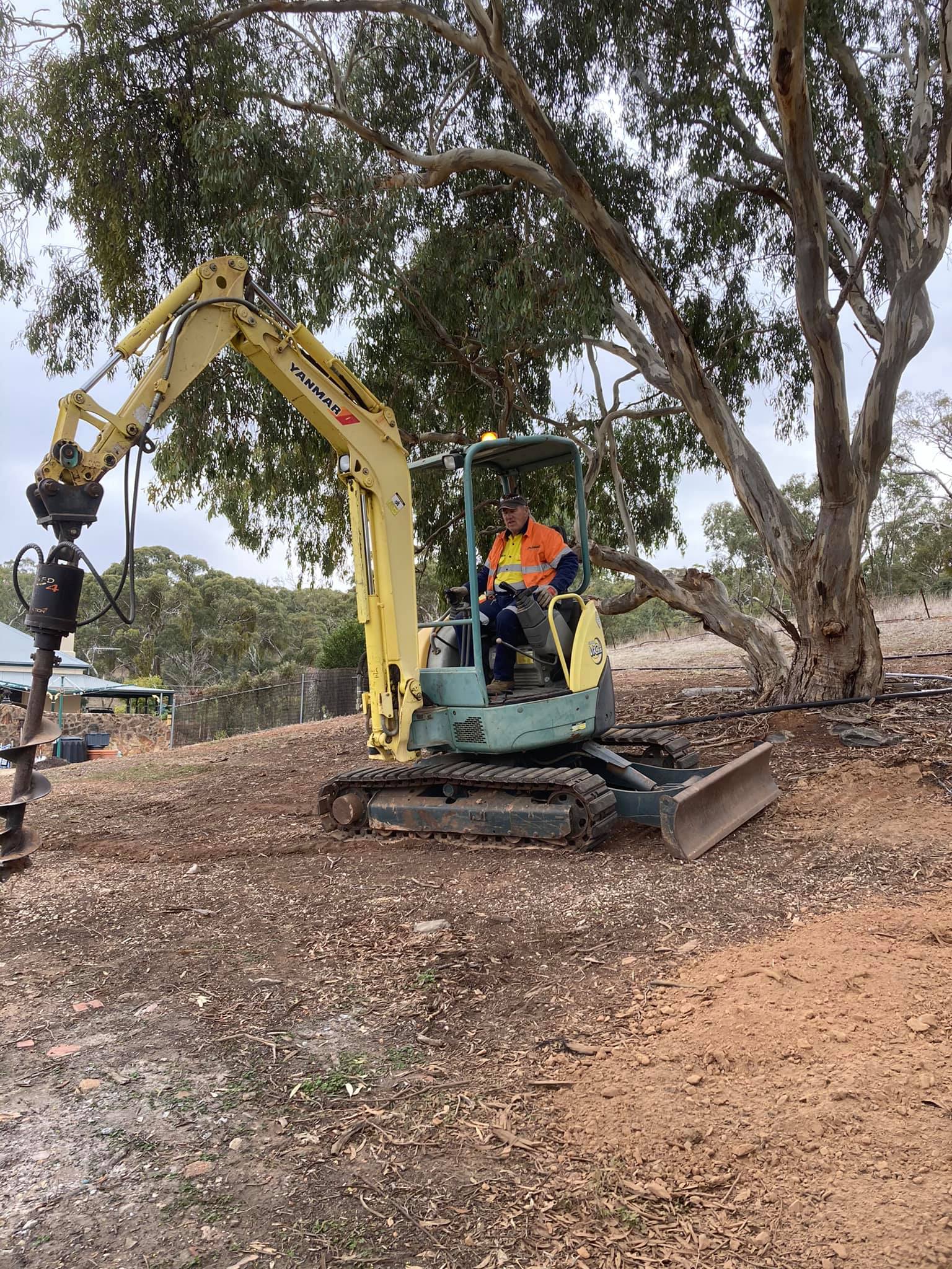 reach excavator with auger attachment